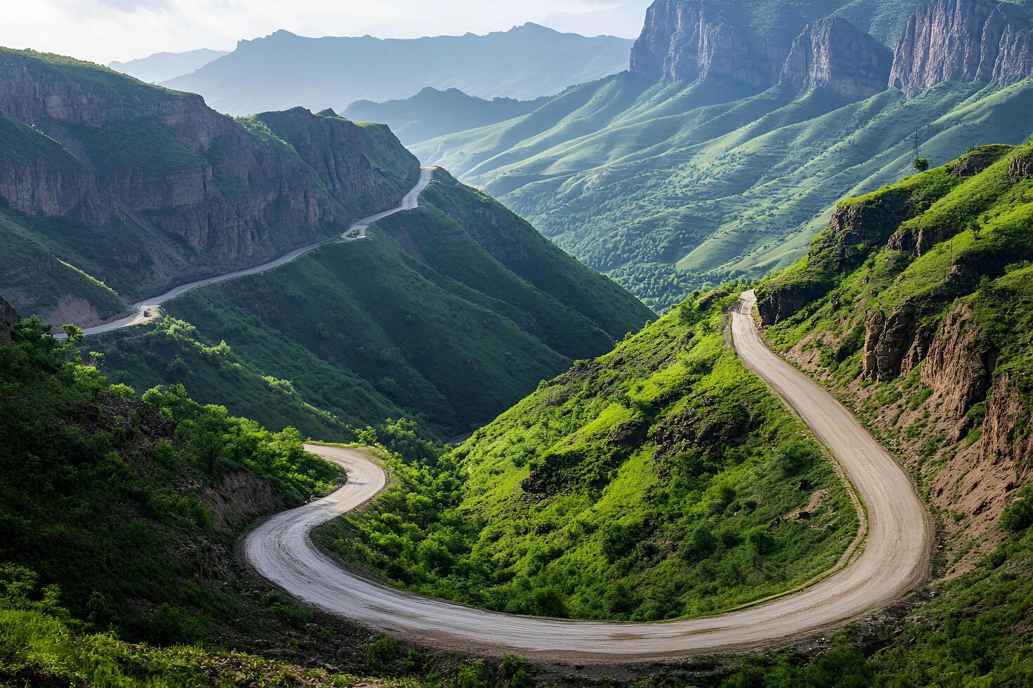 Twisting Mountain Road with Sharp Hairpin Curves and Breathtaking Valley Views, Framed by a Clean White Background photo