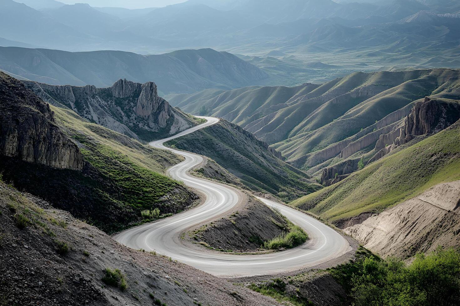 Twisting Mountain Road with Sharp Hairpin Curves and Breathtaking Valley Views, Framed by a Clean White Background photo