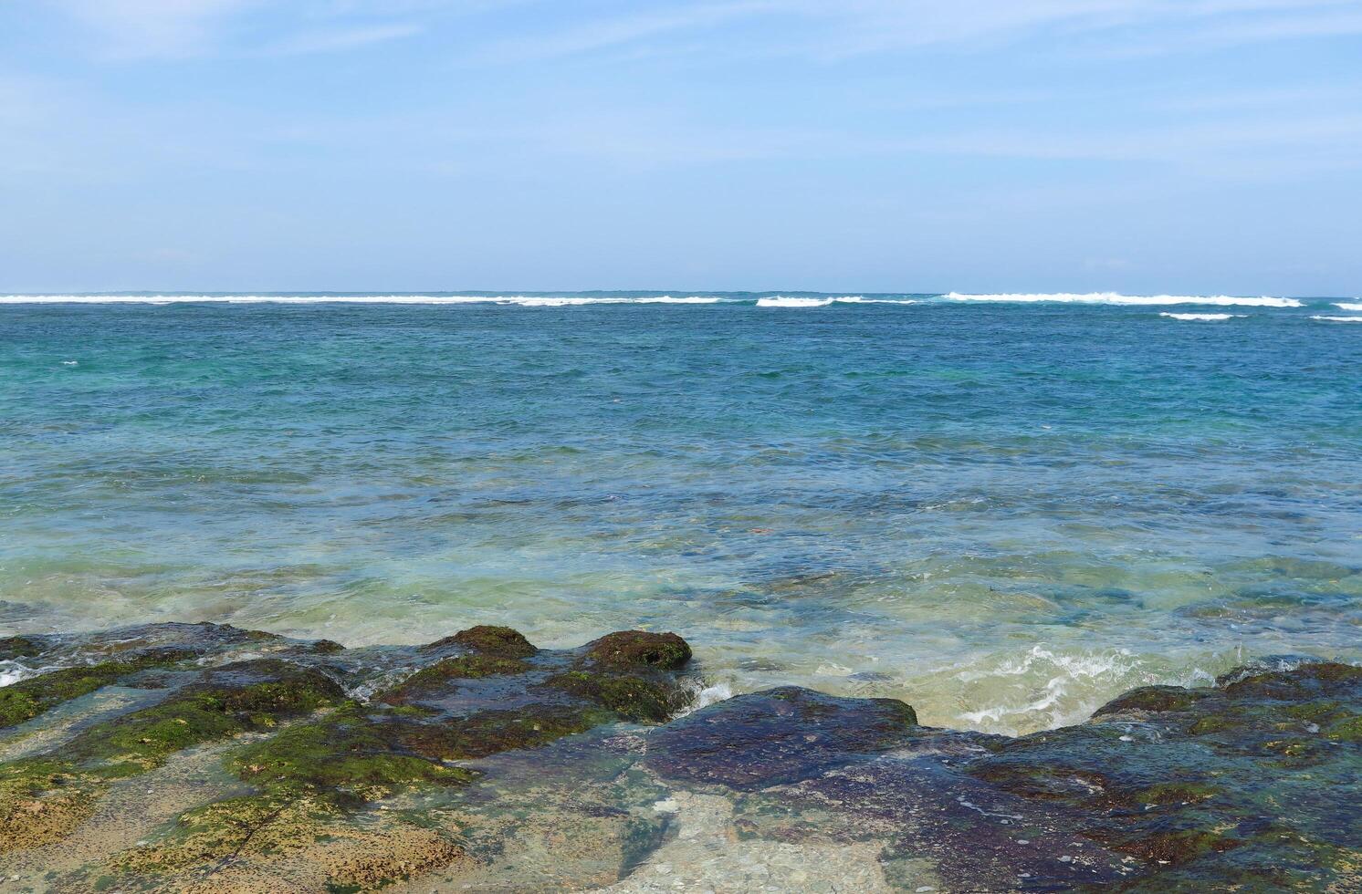 Beautiful sea view with blue sky and white clouds. Deep blue sea is very clear with small waves at Balaikambang beach malang Indonesia photo