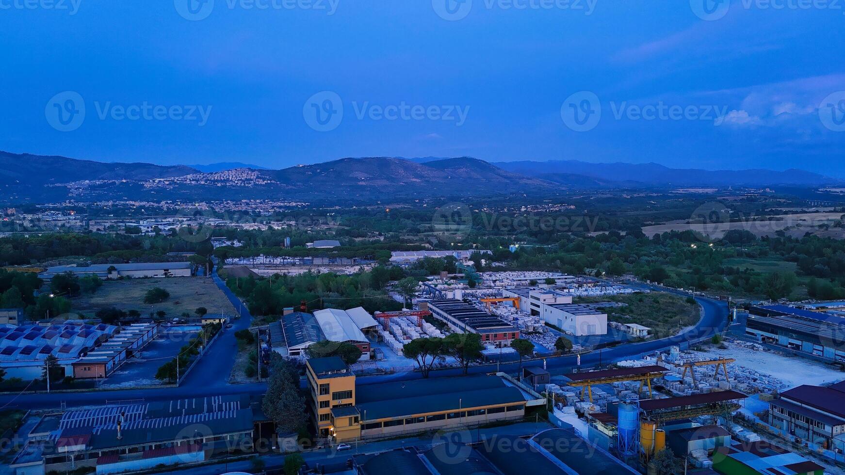 Marble processing factory at dawn with mountains in background photo