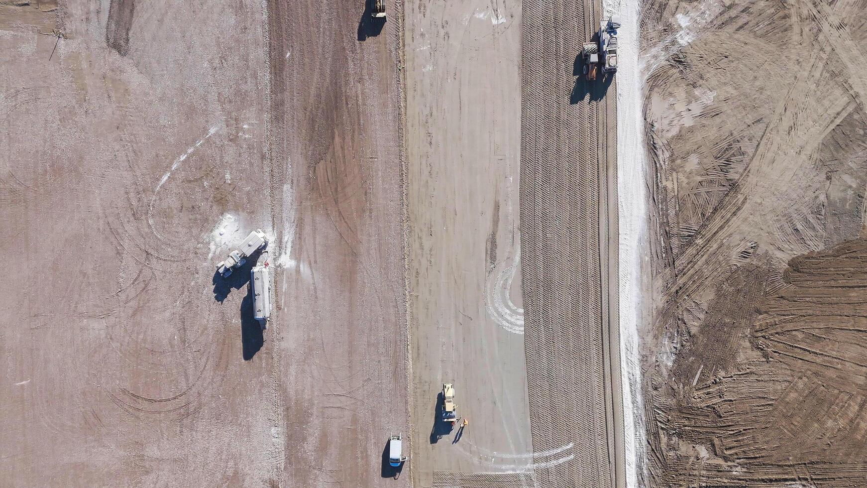 Earthmoving equipment. Aerial view of a large construction site with several earthmoving machines. photo