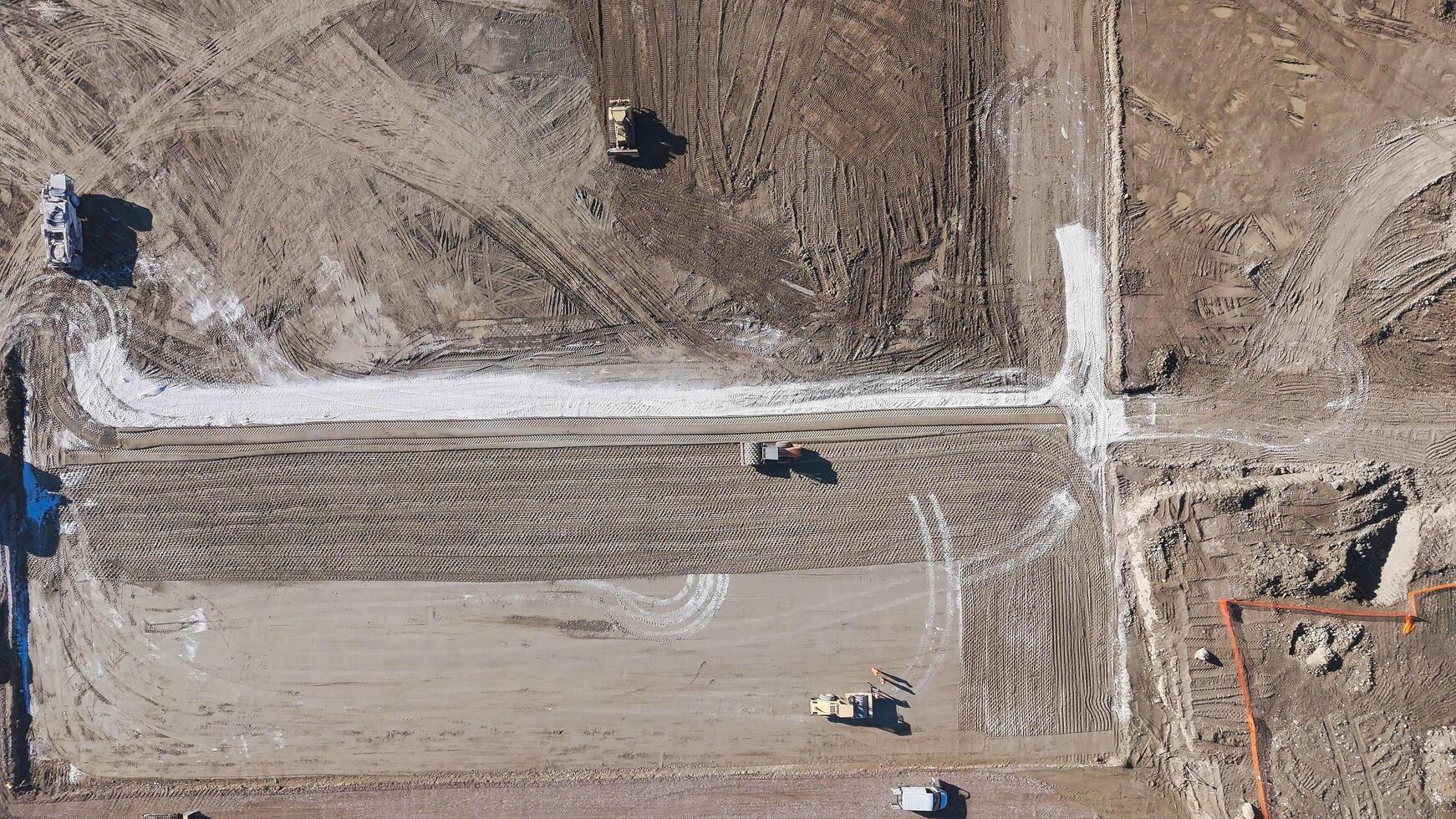 Earthmoving equipment. Aerial view of a large construction site with several earthmoving machines. photo