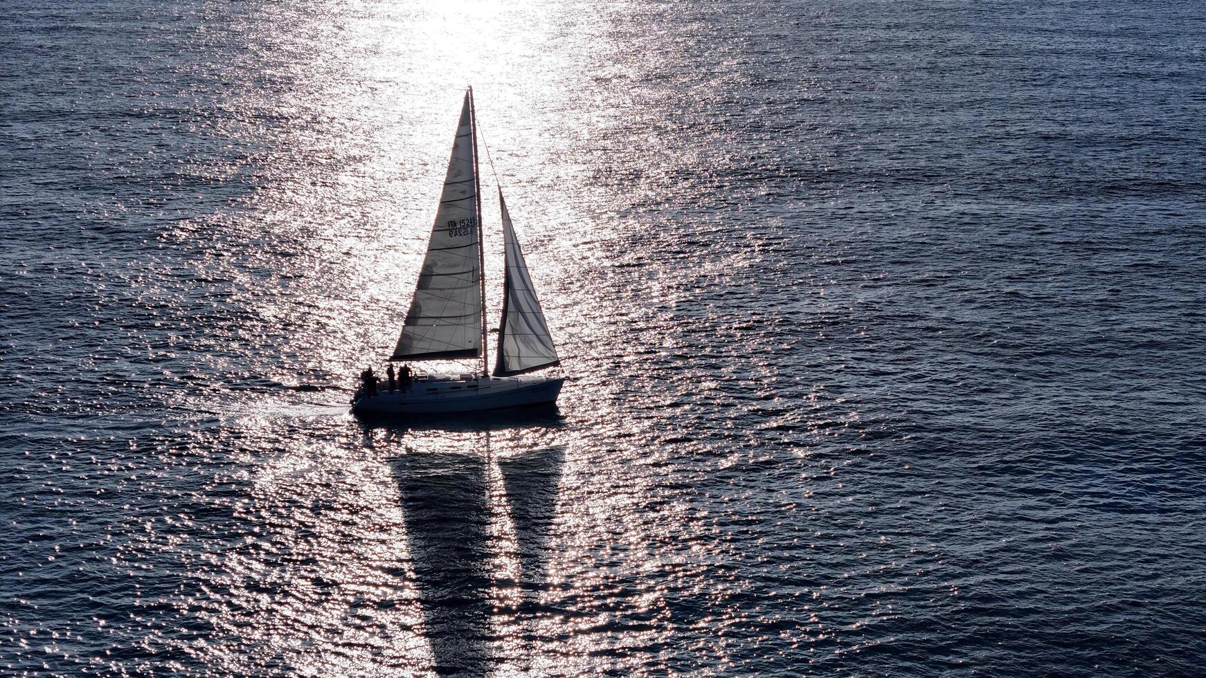 A tranquil sailing adventure in the shimmering waters at sunset, capturing the essence of peaceful nautical exploration photo