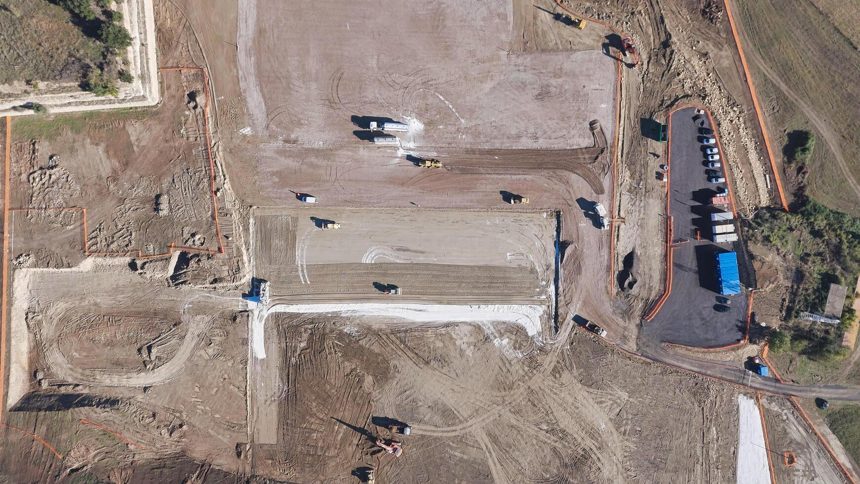 Earthmoving equipment. Aerial view of a large construction site with several earthmoving machines. photo