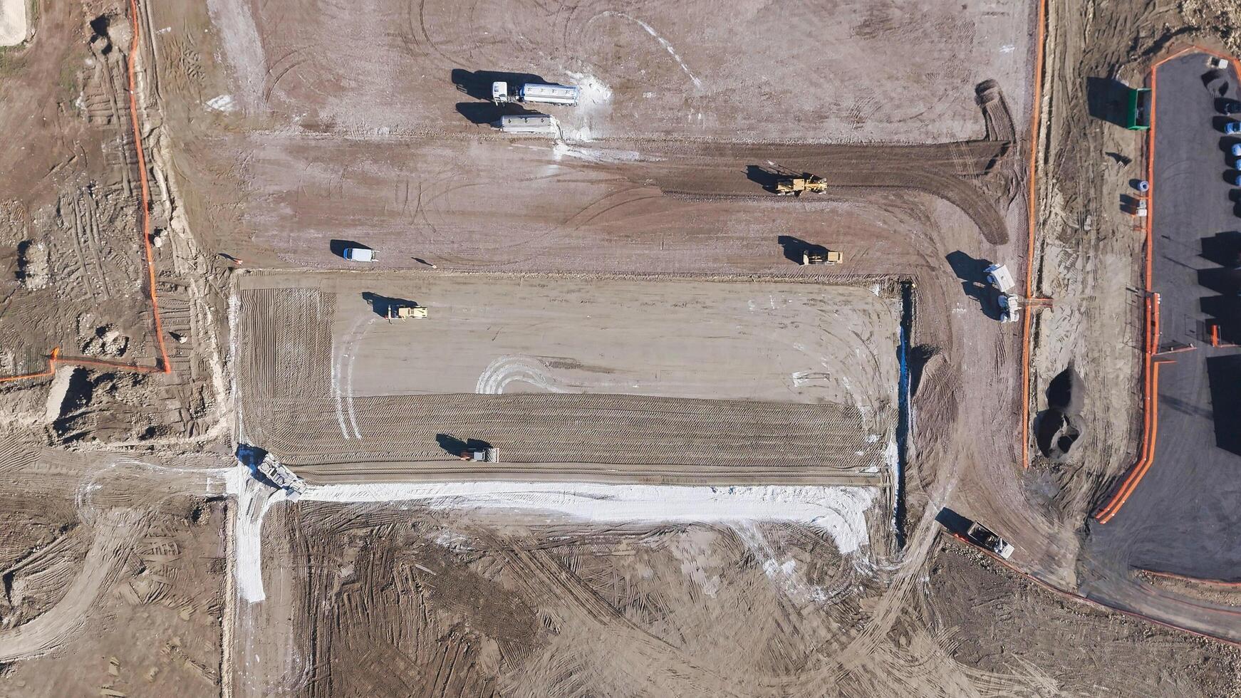 Earthmoving equipment. Aerial view of a large construction site with several earthmoving machines. photo