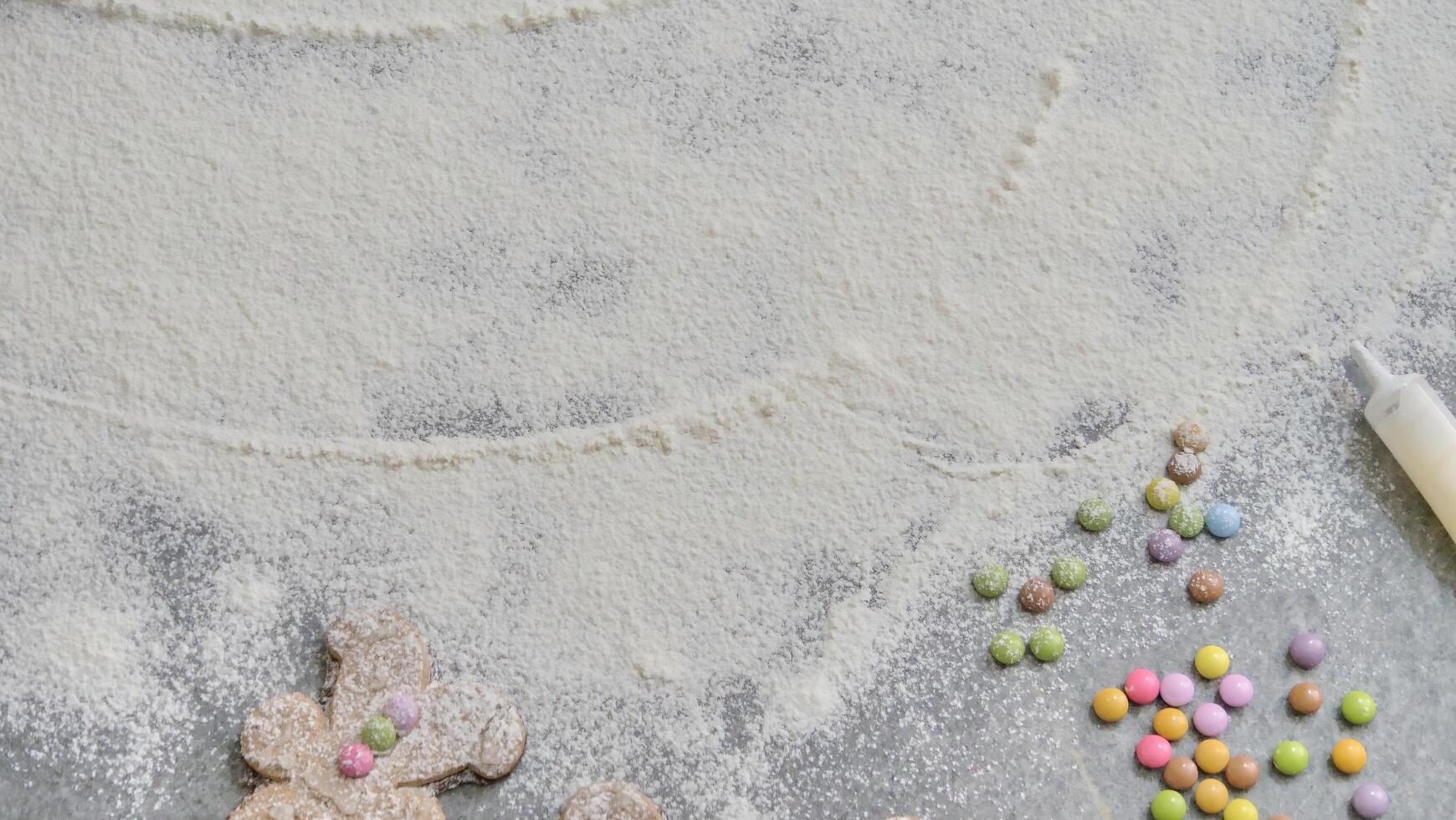 a child's hand draws 2024 in flour photo