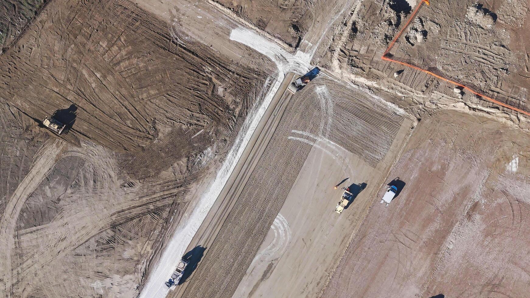 Earthmoving equipment. Aerial view of a large construction site with several earthmoving machines. photo