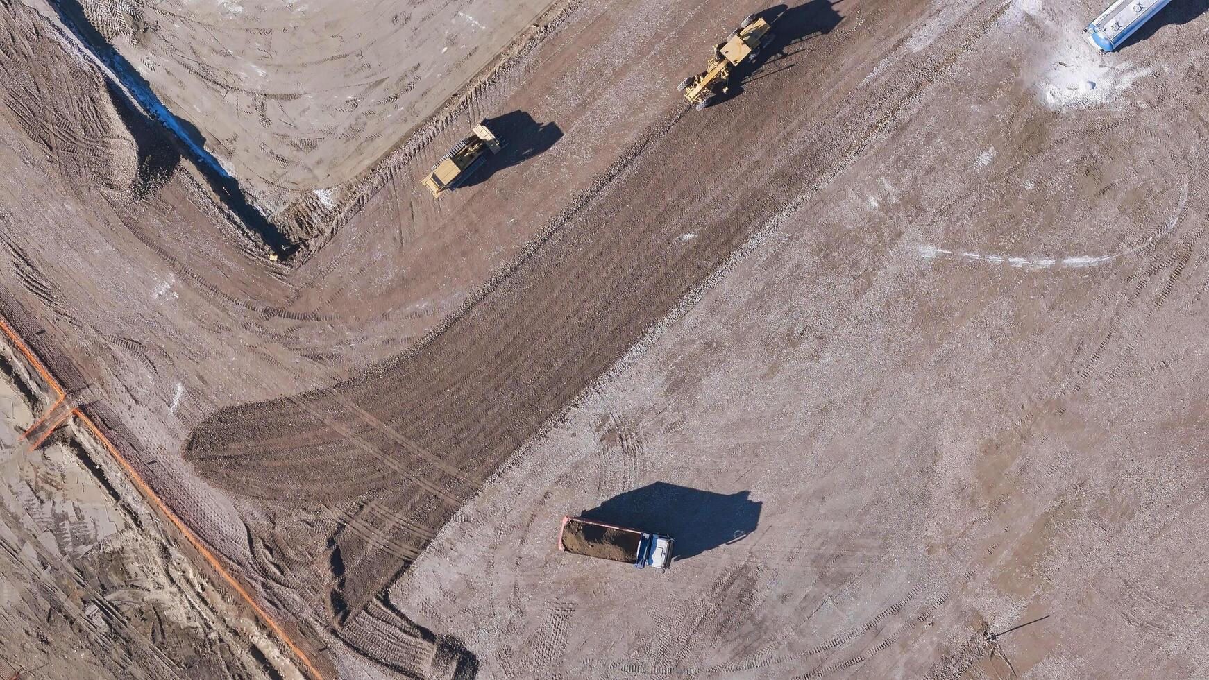 Earthmoving equipment. Aerial view of a large construction site with several earthmoving machines. photo