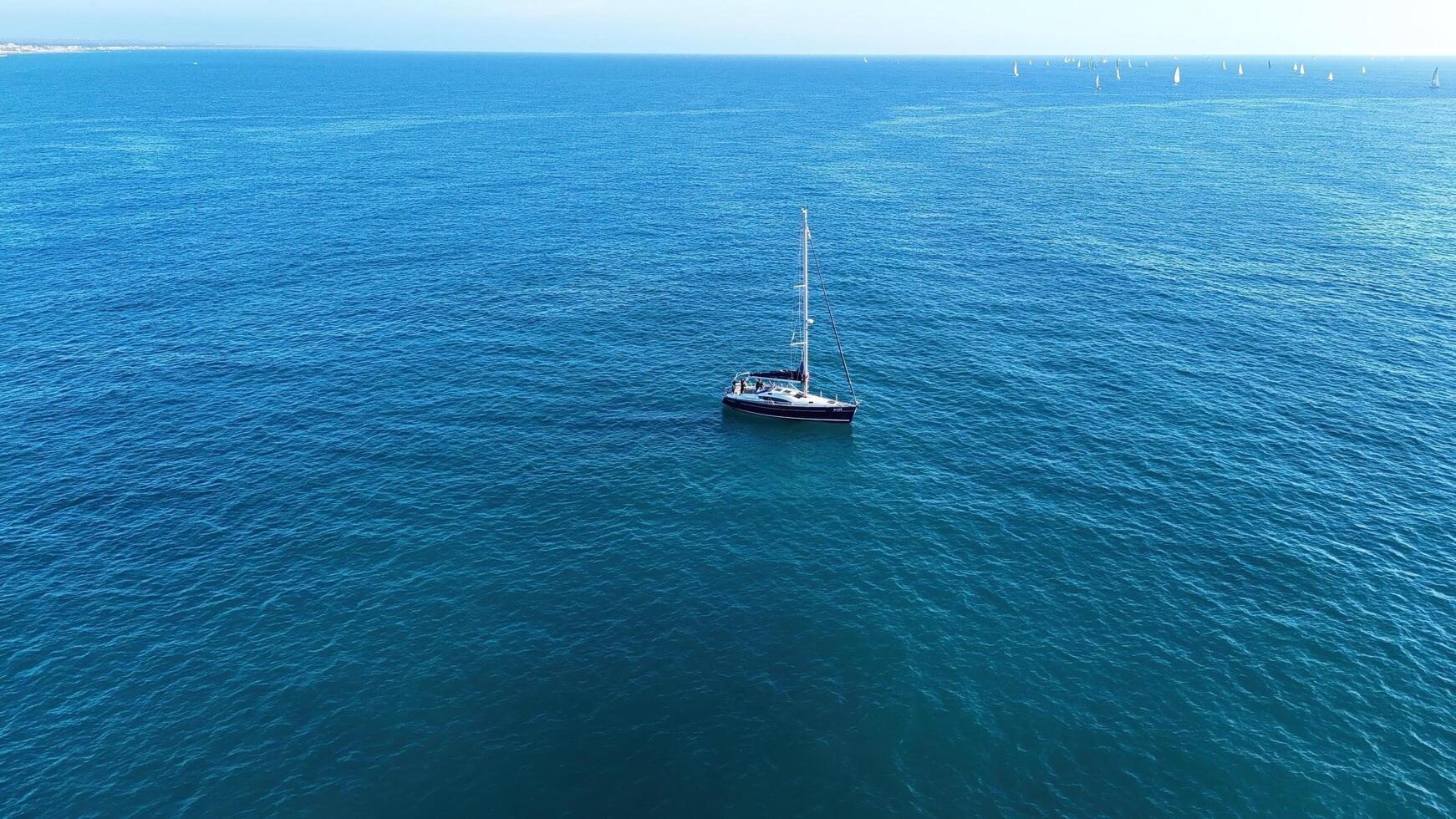 A serene sailing adventure on calm waters under a clear blue sky during a peaceful afternoon photo