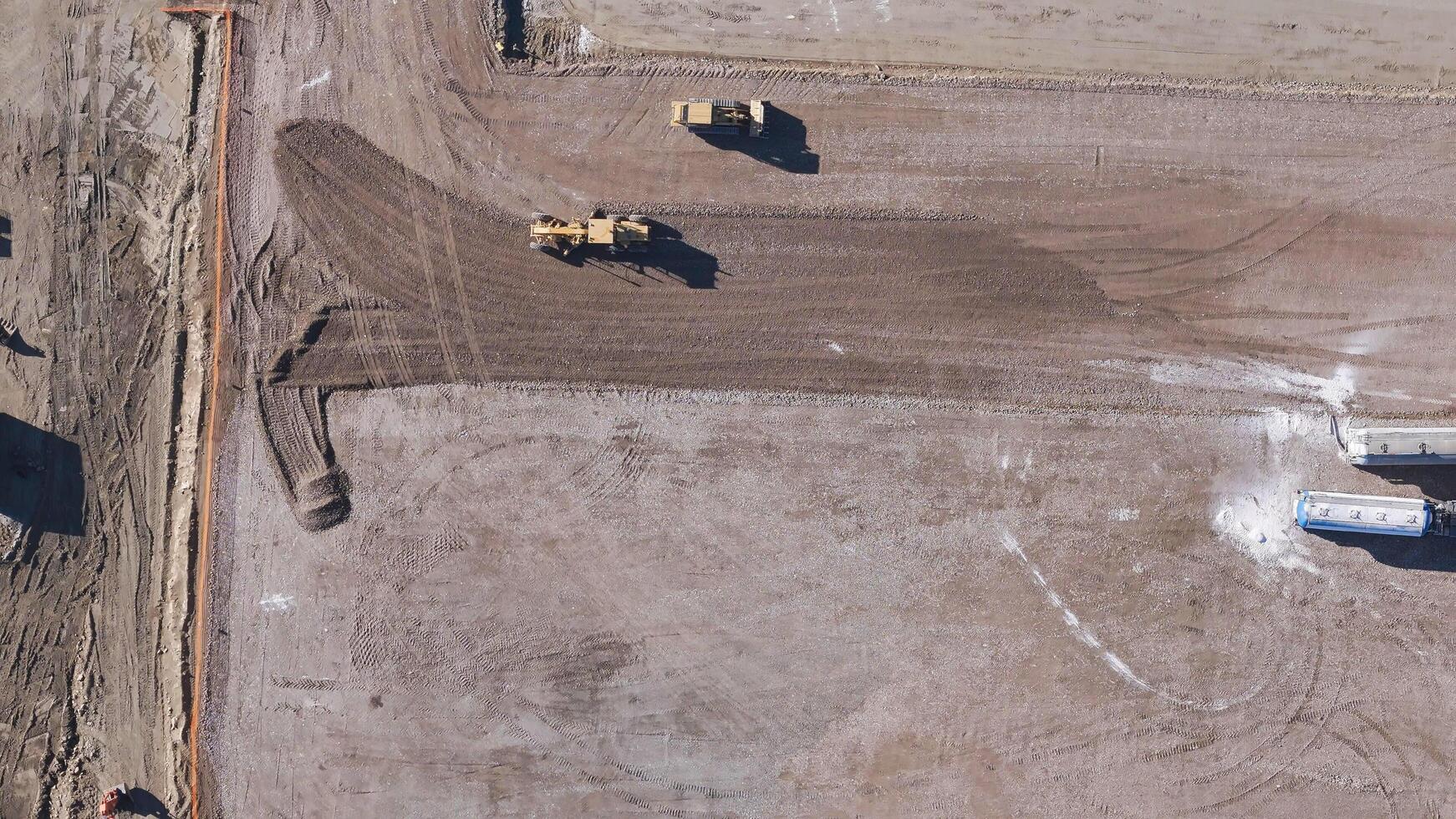 Earthmoving equipment. Aerial view of a large construction site with several earthmoving machines. photo