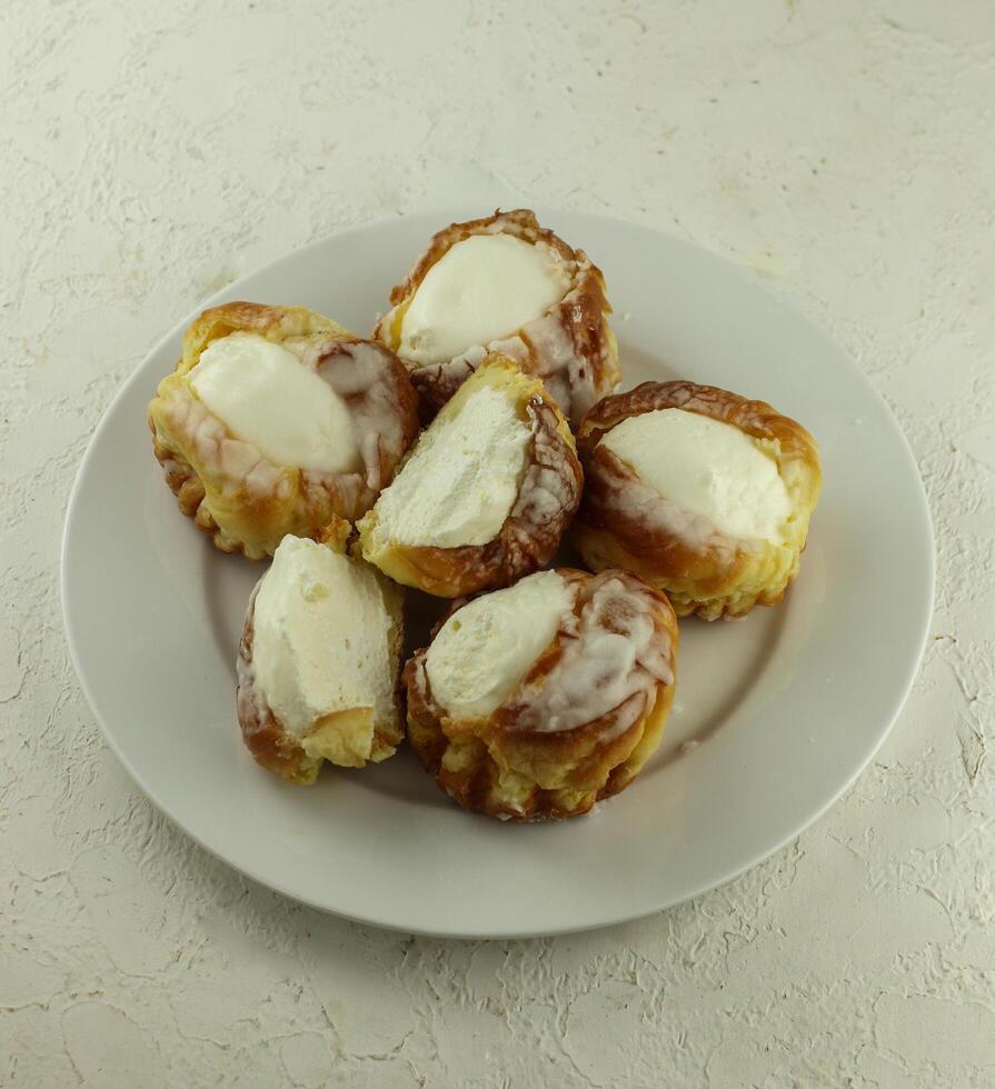 eclairs with vla or custard filling served on a plate photo