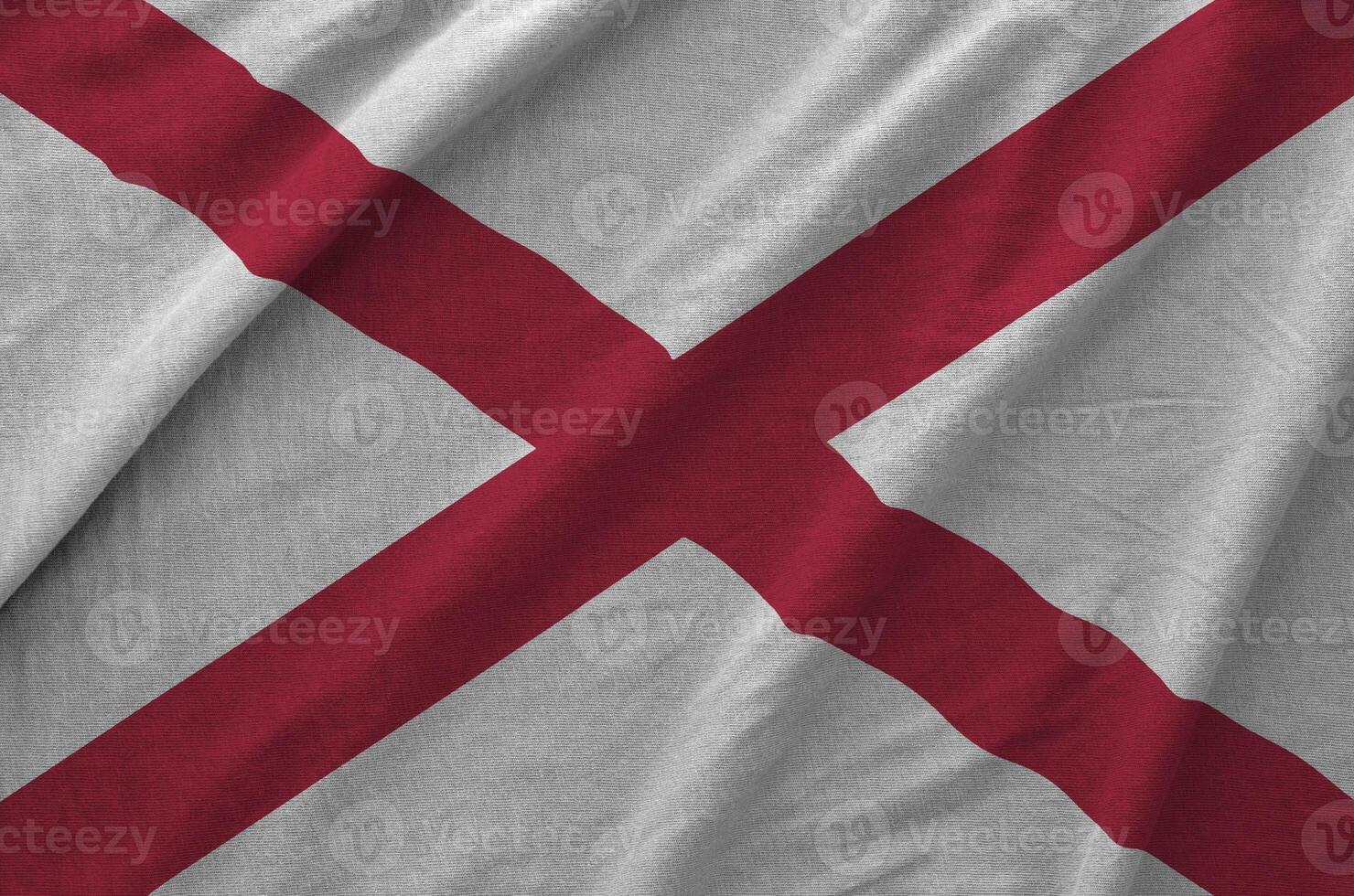 Alabama US state flag depicted on folded wavy fabric of old cloth photo