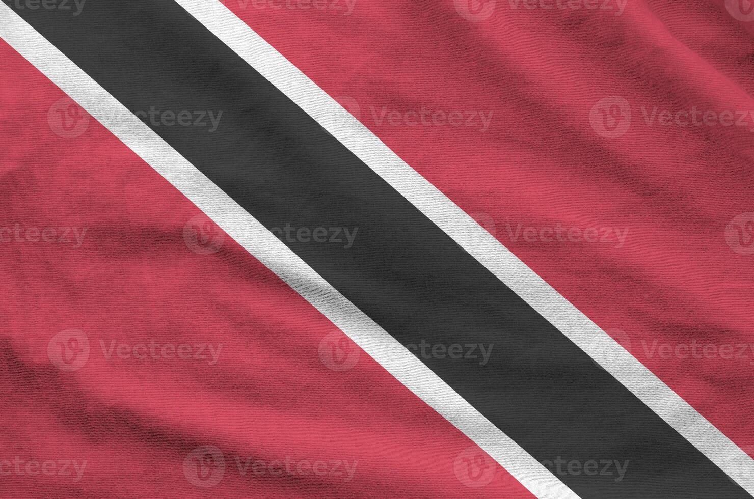 Trinidad and Tobago flag depicted on folded wavy fabric of old cloth photo