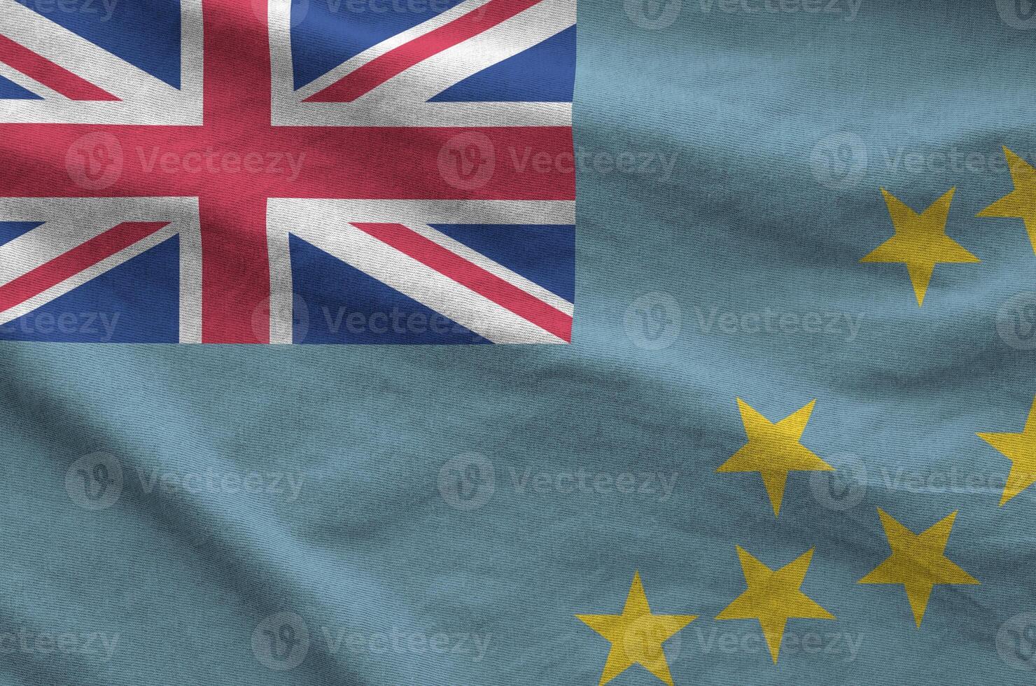 Tuvalu flag depicted on folded wavy fabric of old cloth photo