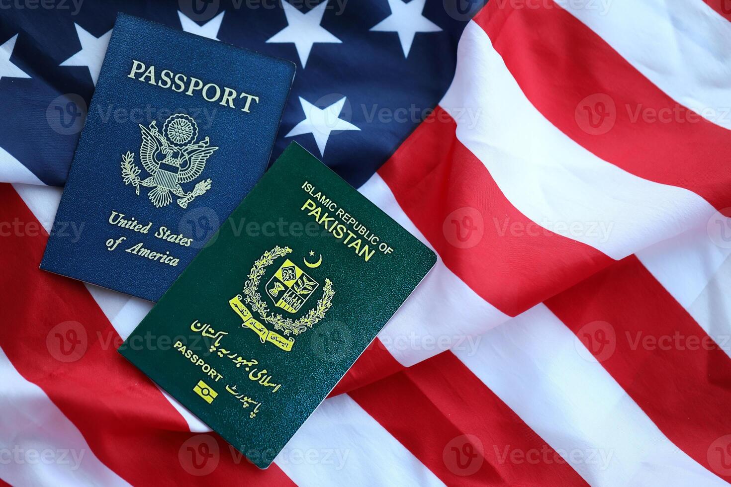 Passport of Pakistan with US Passport on United States of America folded flag photo