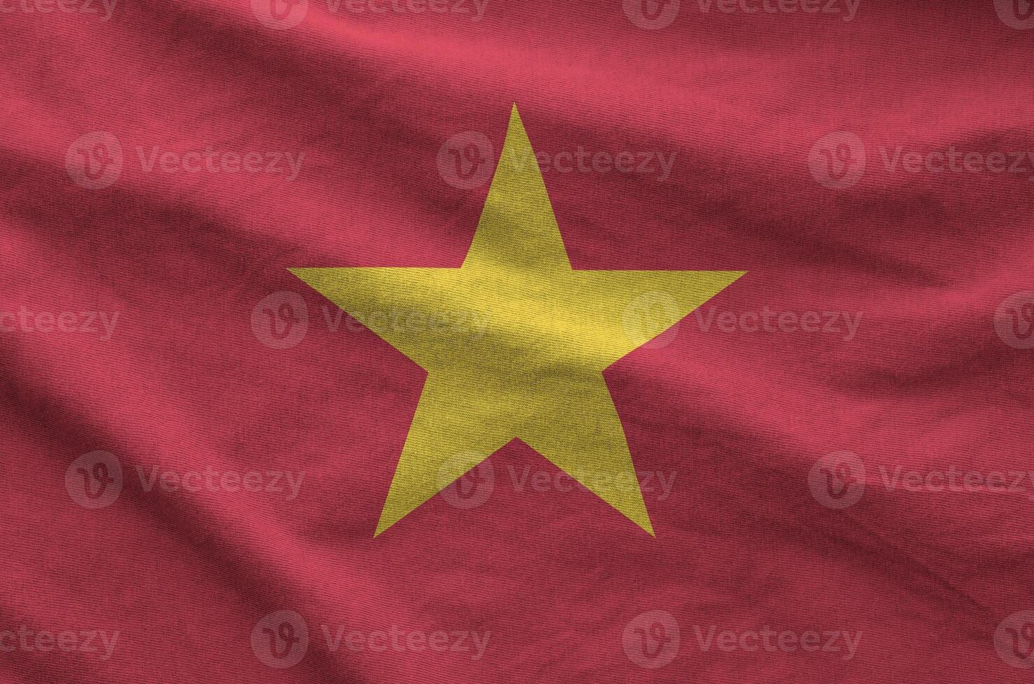 Vietnam flag depicted on folded wavy fabric of old cloth photo