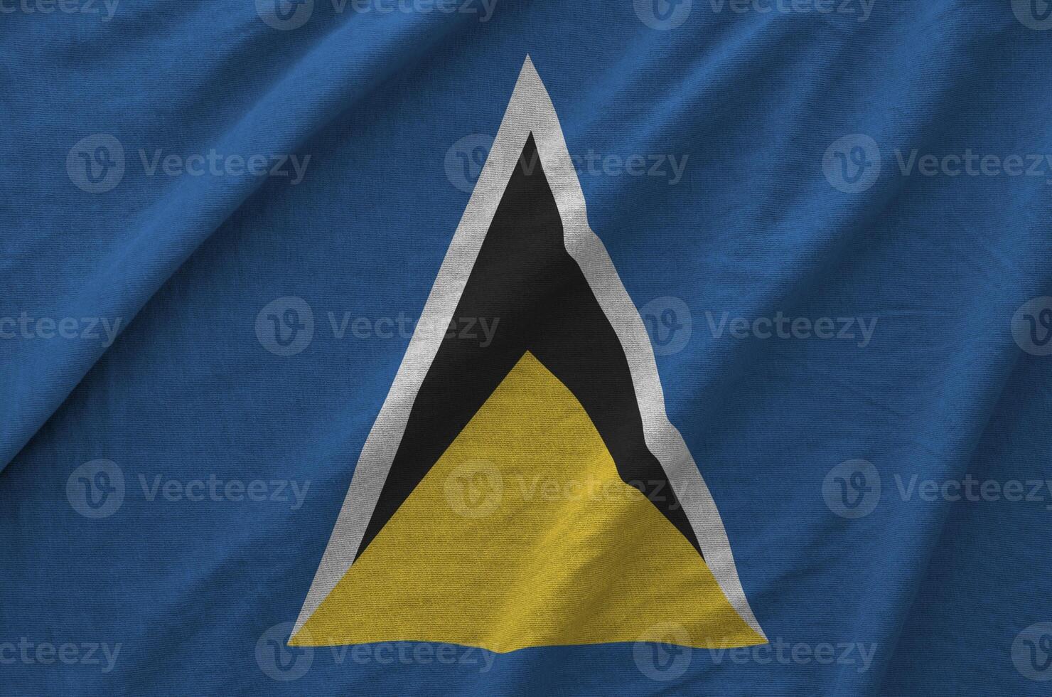 Saint Lucia flag depicted on folded wavy fabric of old cloth photo