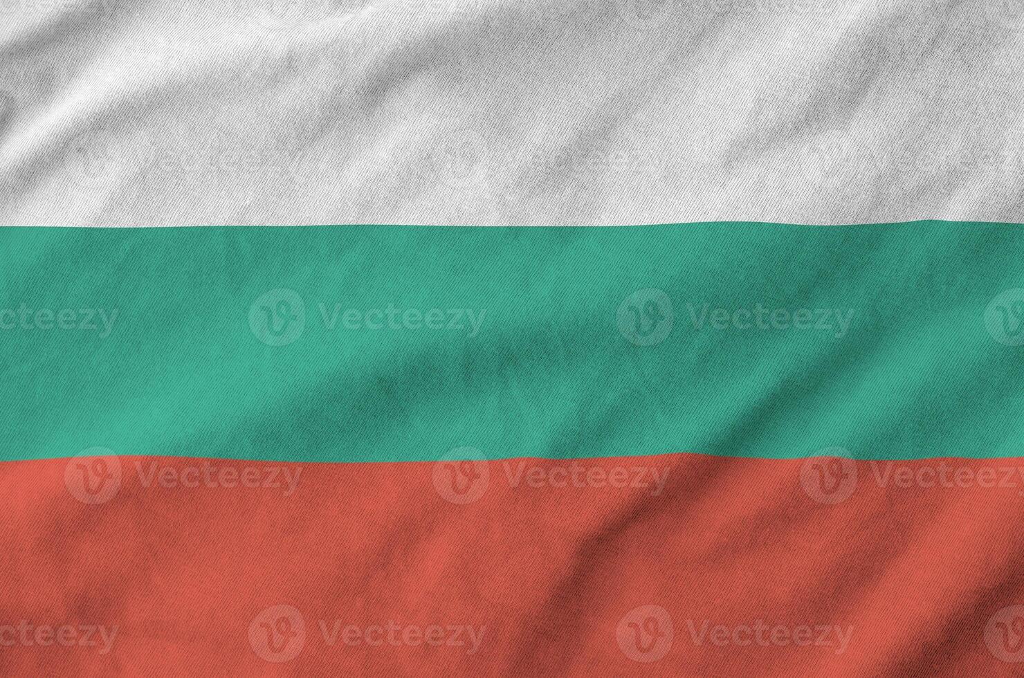 Bulgaria flag depicted on folded wavy fabric of old cloth photo
