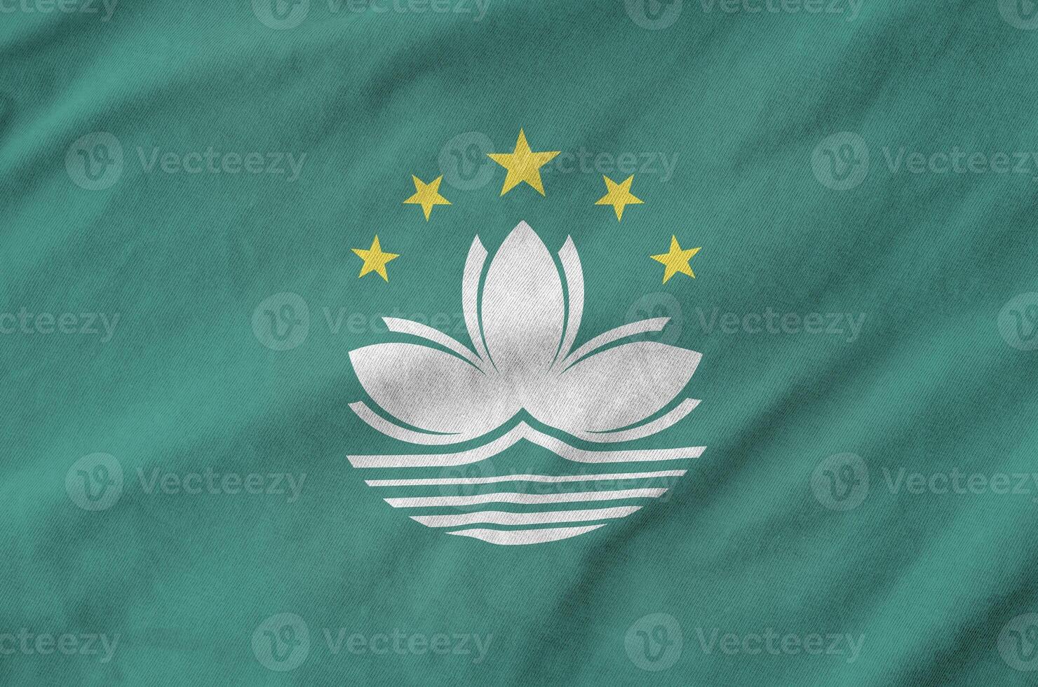 Macau flag depicted on folded wavy fabric of old cloth photo