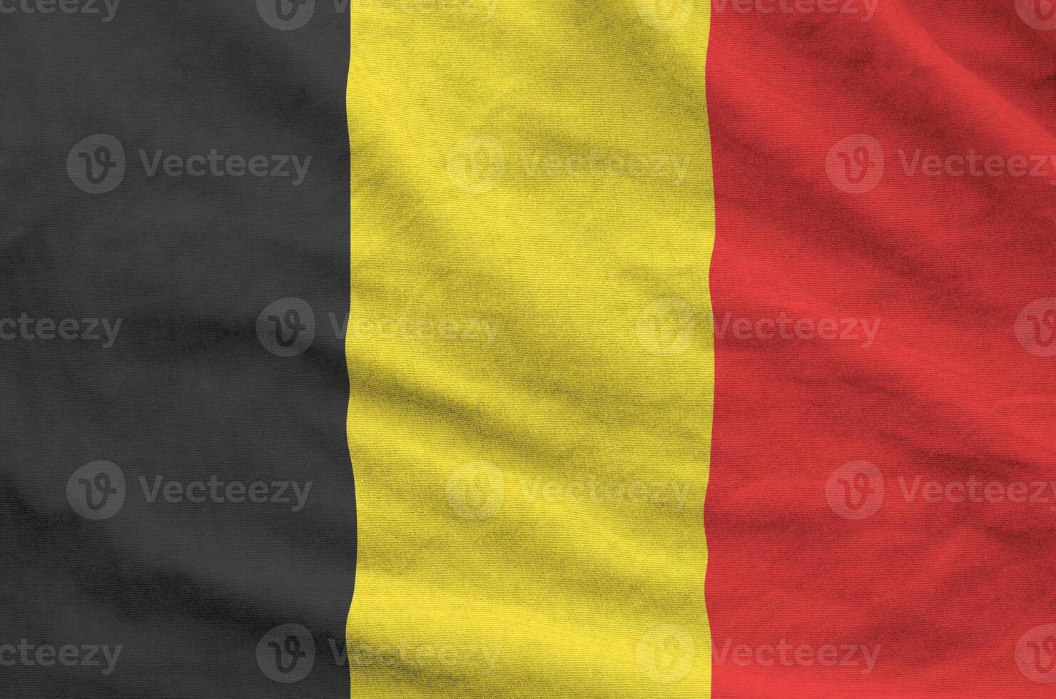 Belgium flag depicted on folded wavy fabric of old cloth photo