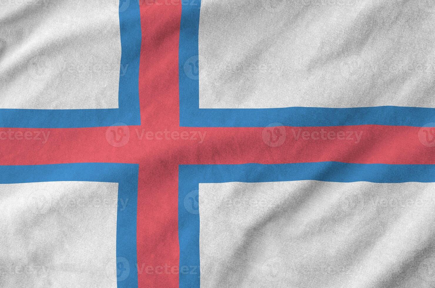 Faroe islands flag depicted on folded wavy fabric of old cloth photo