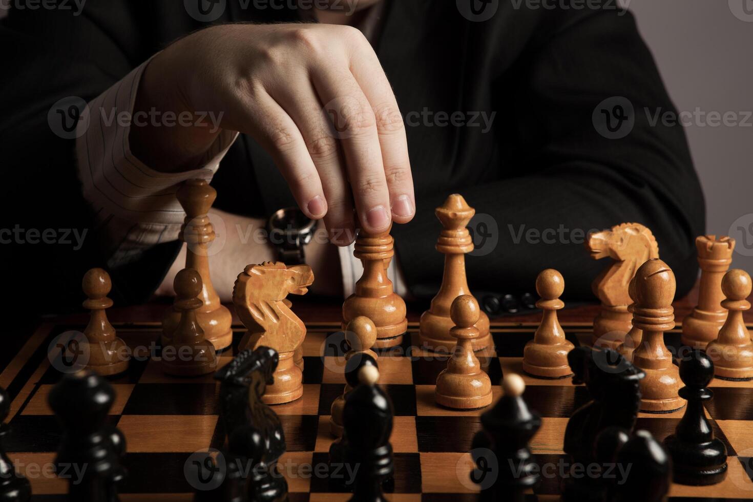 man makes a move chess figure photo