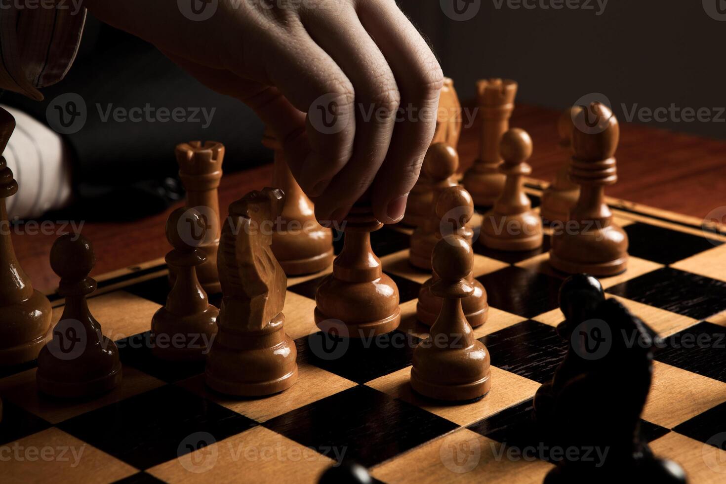man makes a move chess figure photo