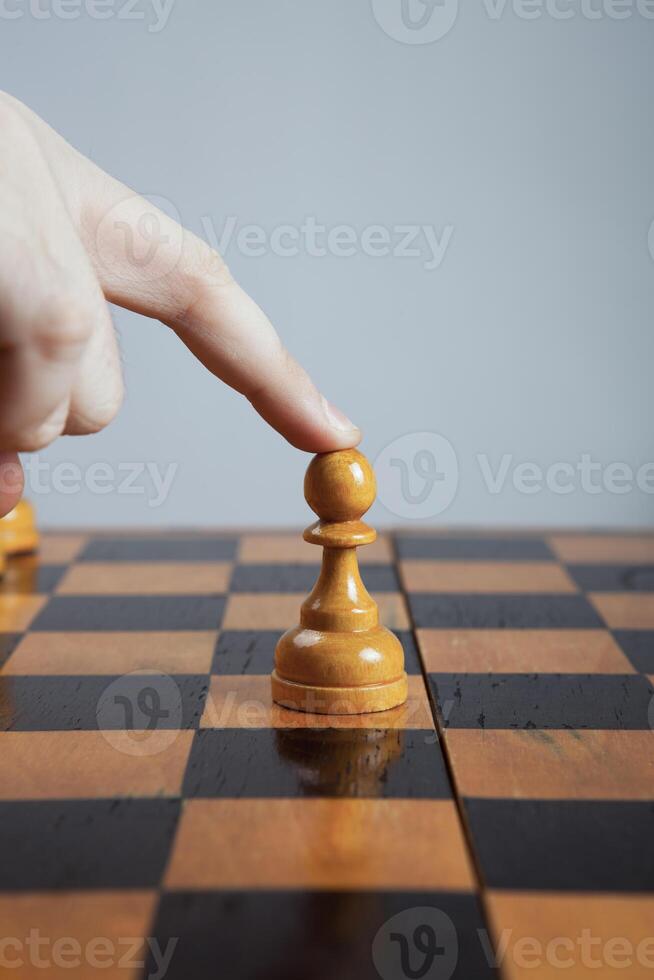 man makes a move chess pawn photo