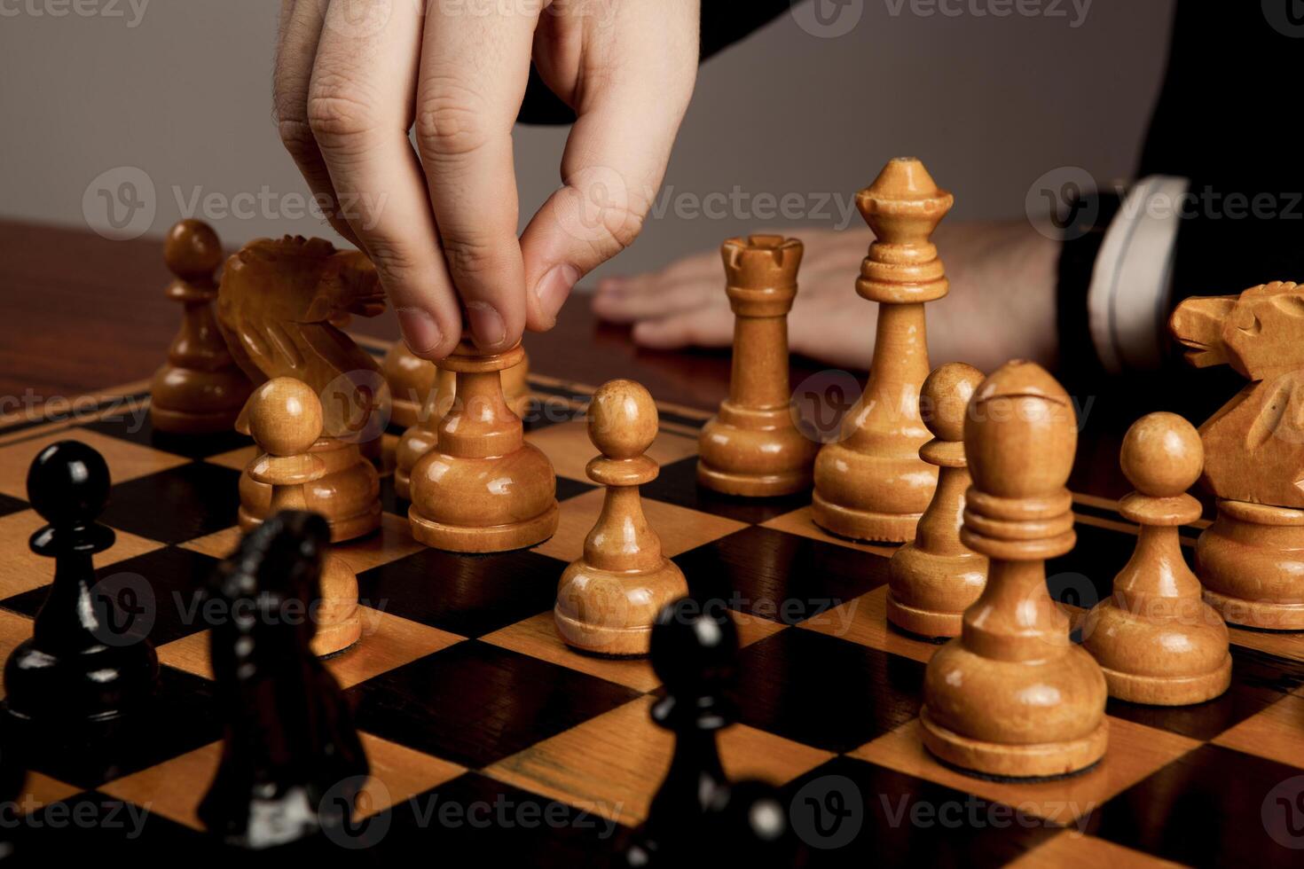 man makes a move chess figure photo