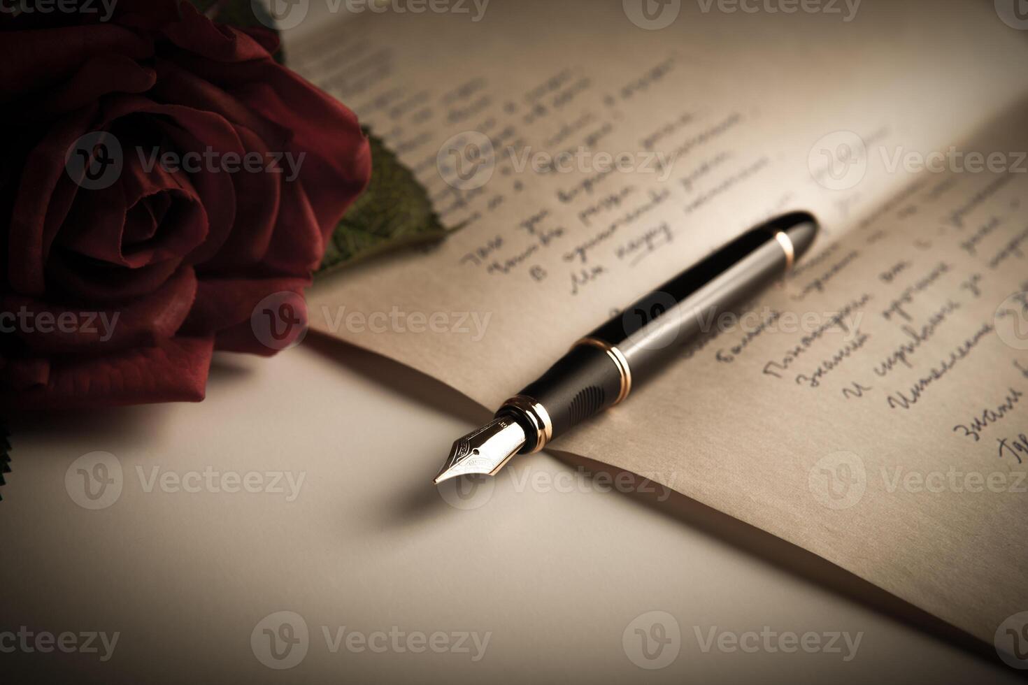 fountain pen on text sheet paper with rose photo