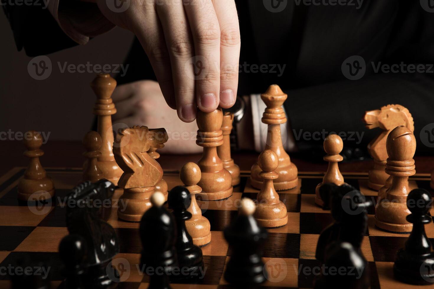 man makes a move chess figure photo