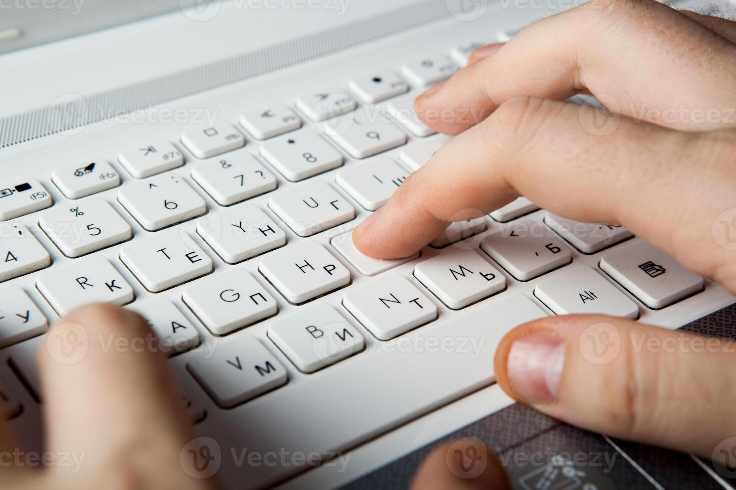 human fingers on the notebook keyboard photo