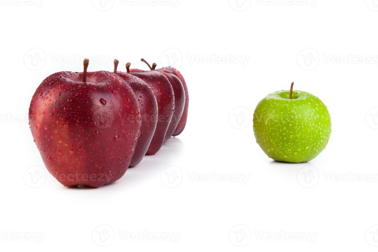 maroon apples lined up in a row and green apple closeup photo