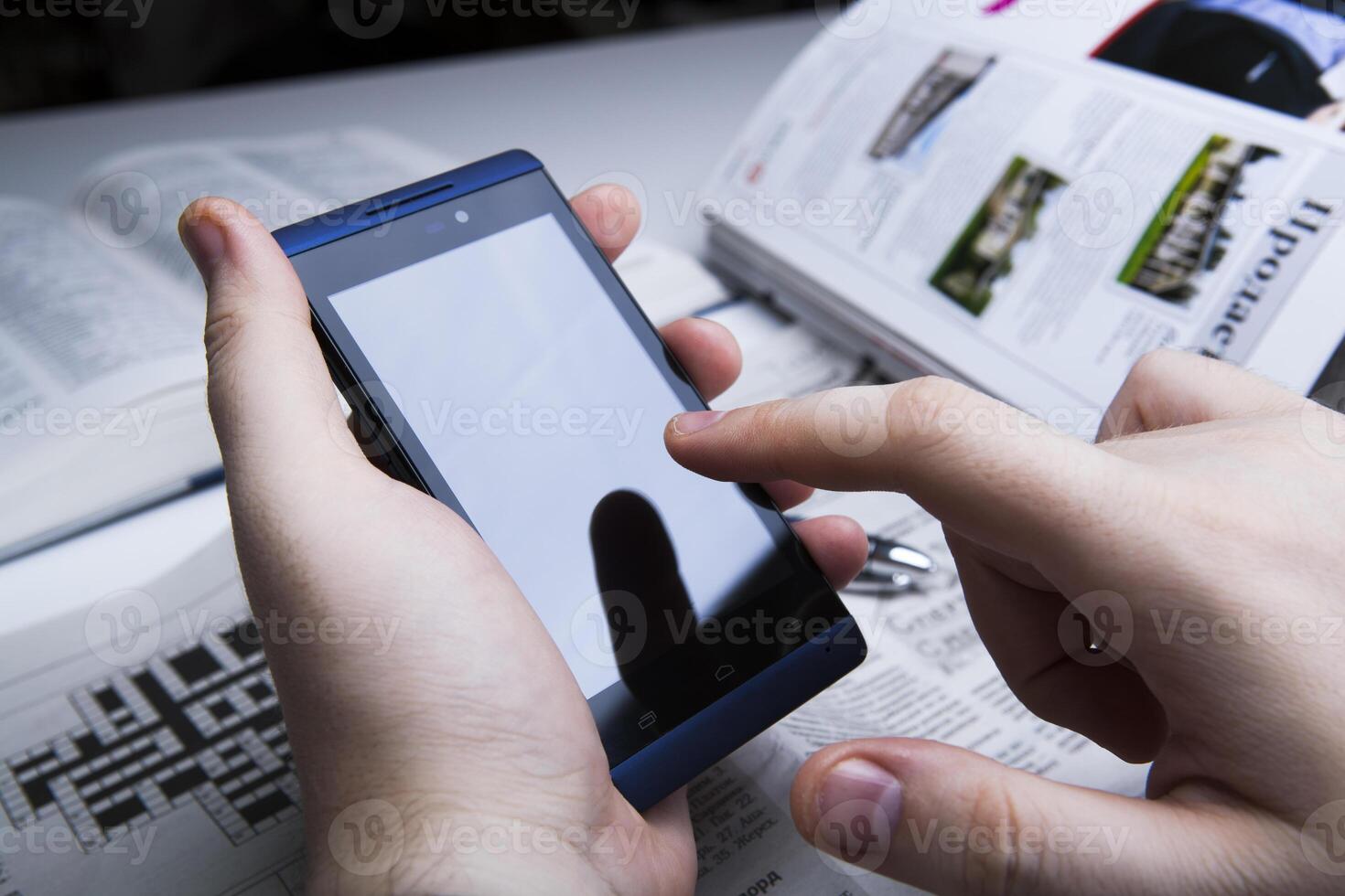 man working on a smartphone in office photo