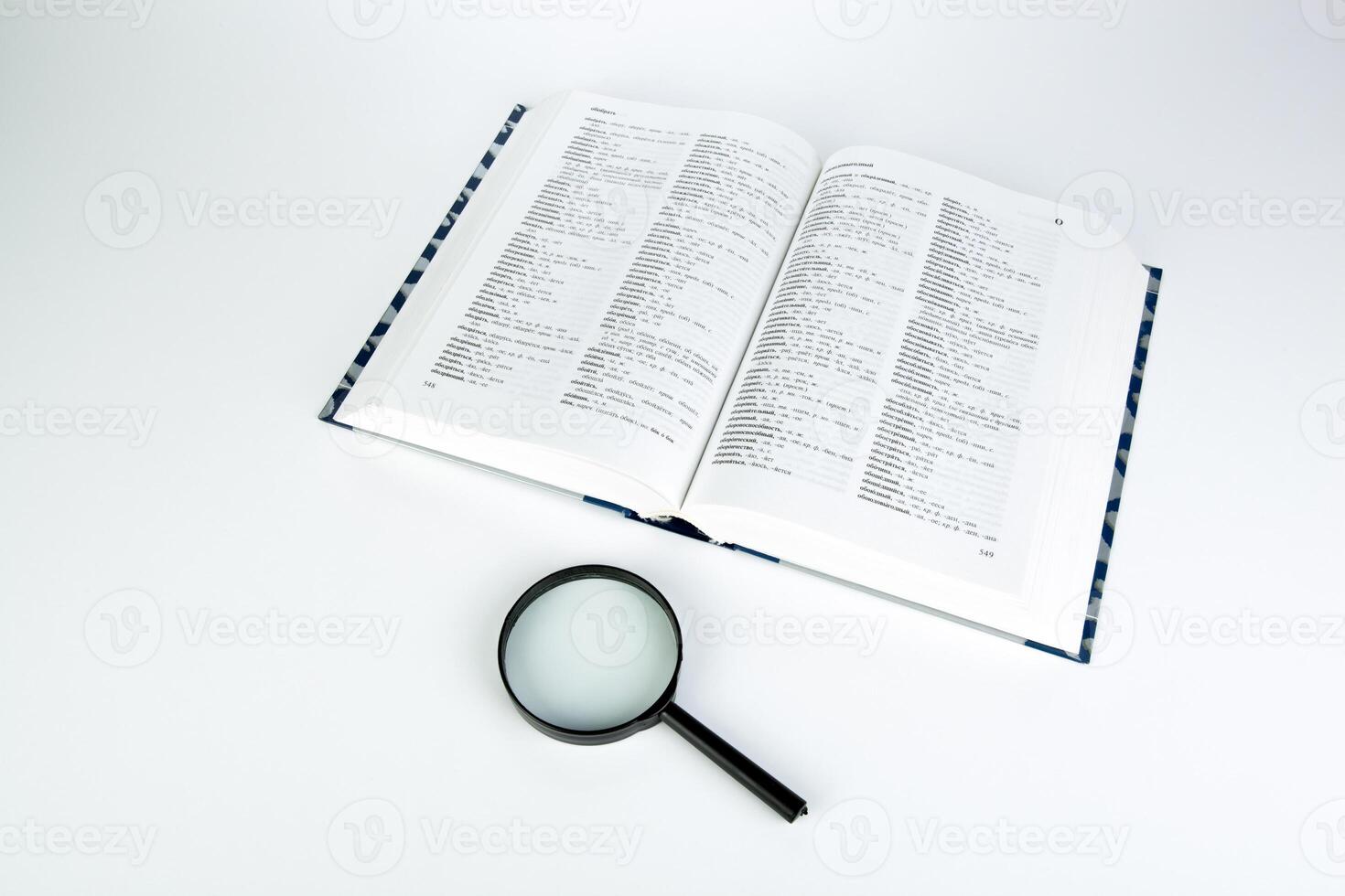 open book with loupe closeup photo