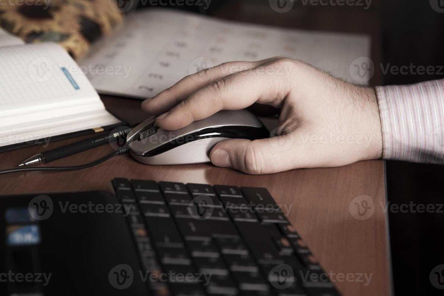 hand on a computer mouse at work photo