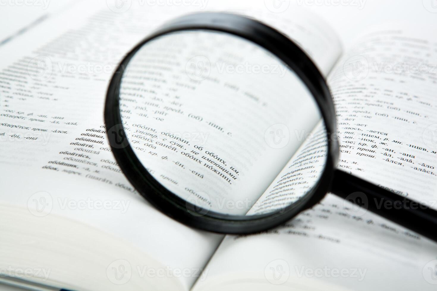 open book with loupe closeup photo
