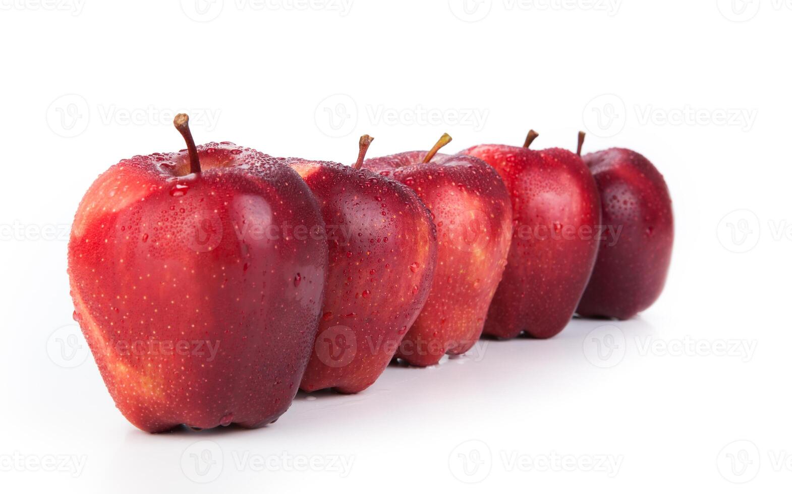 maroon apples lined up in a row closeup photo