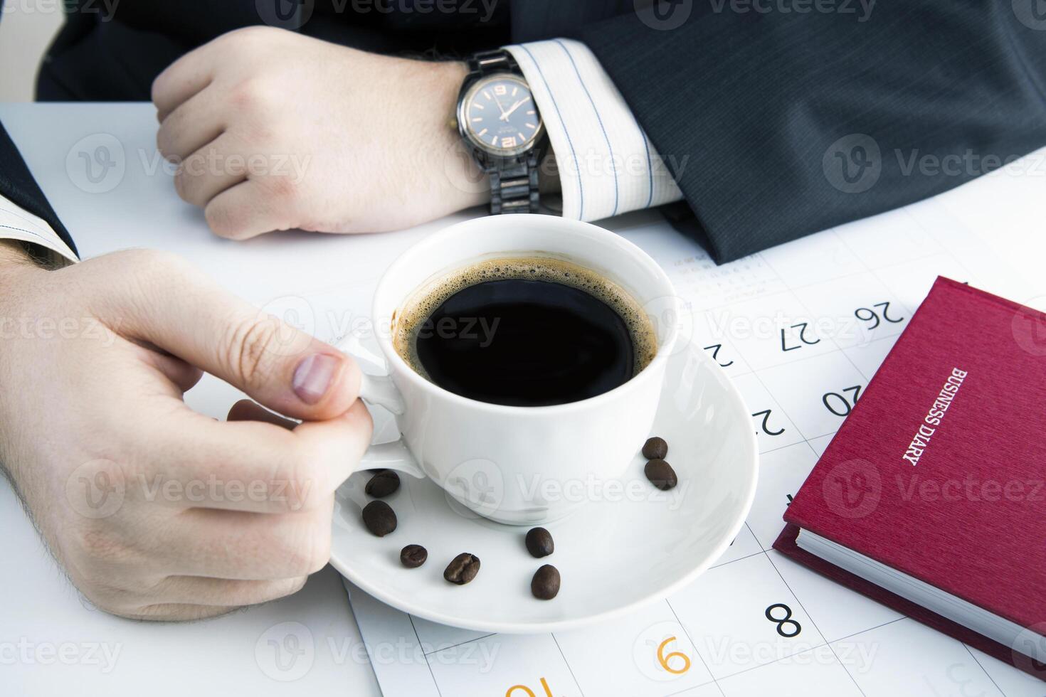 man and cup of coffee in the workplace photo