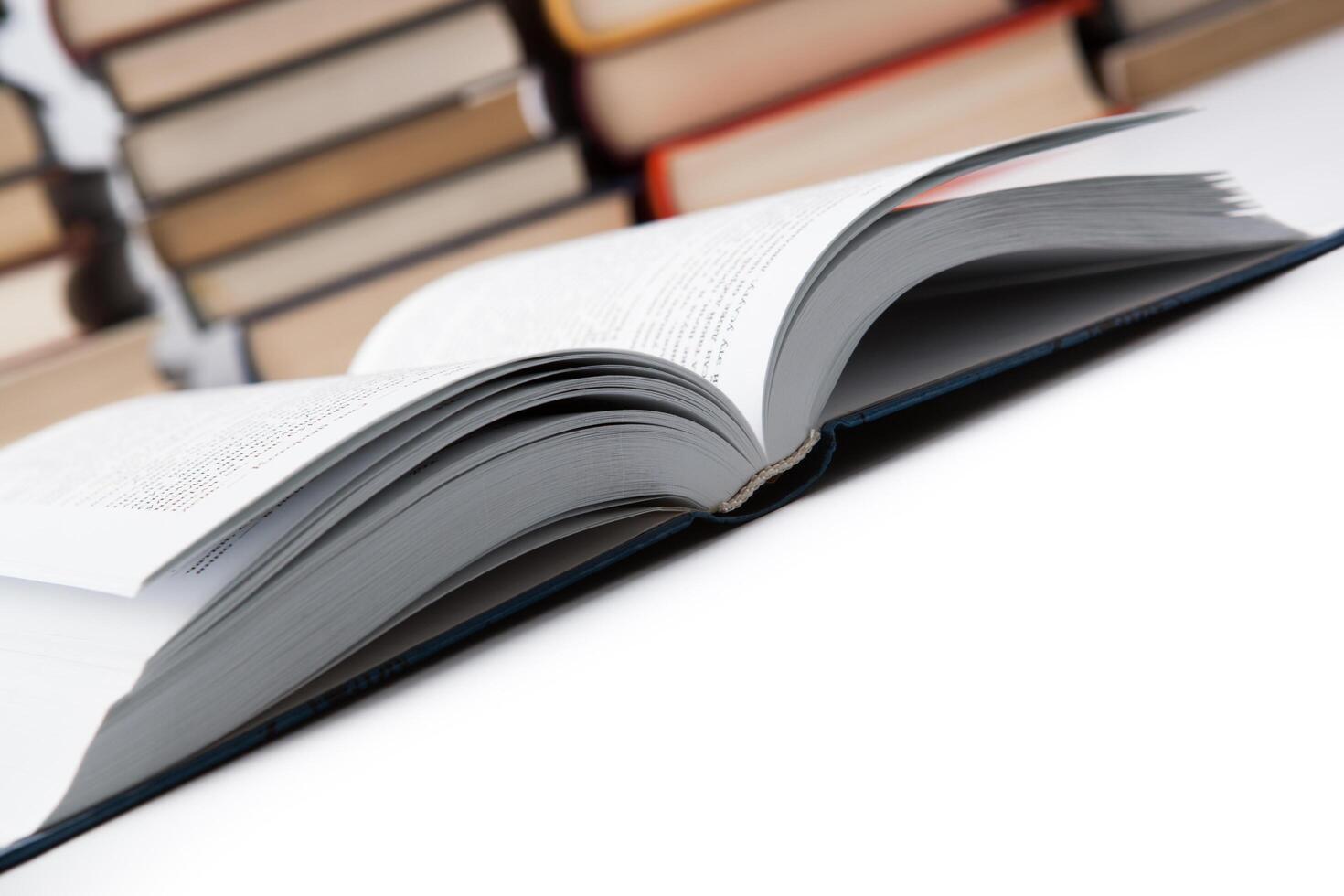 open book on with pile of books photo