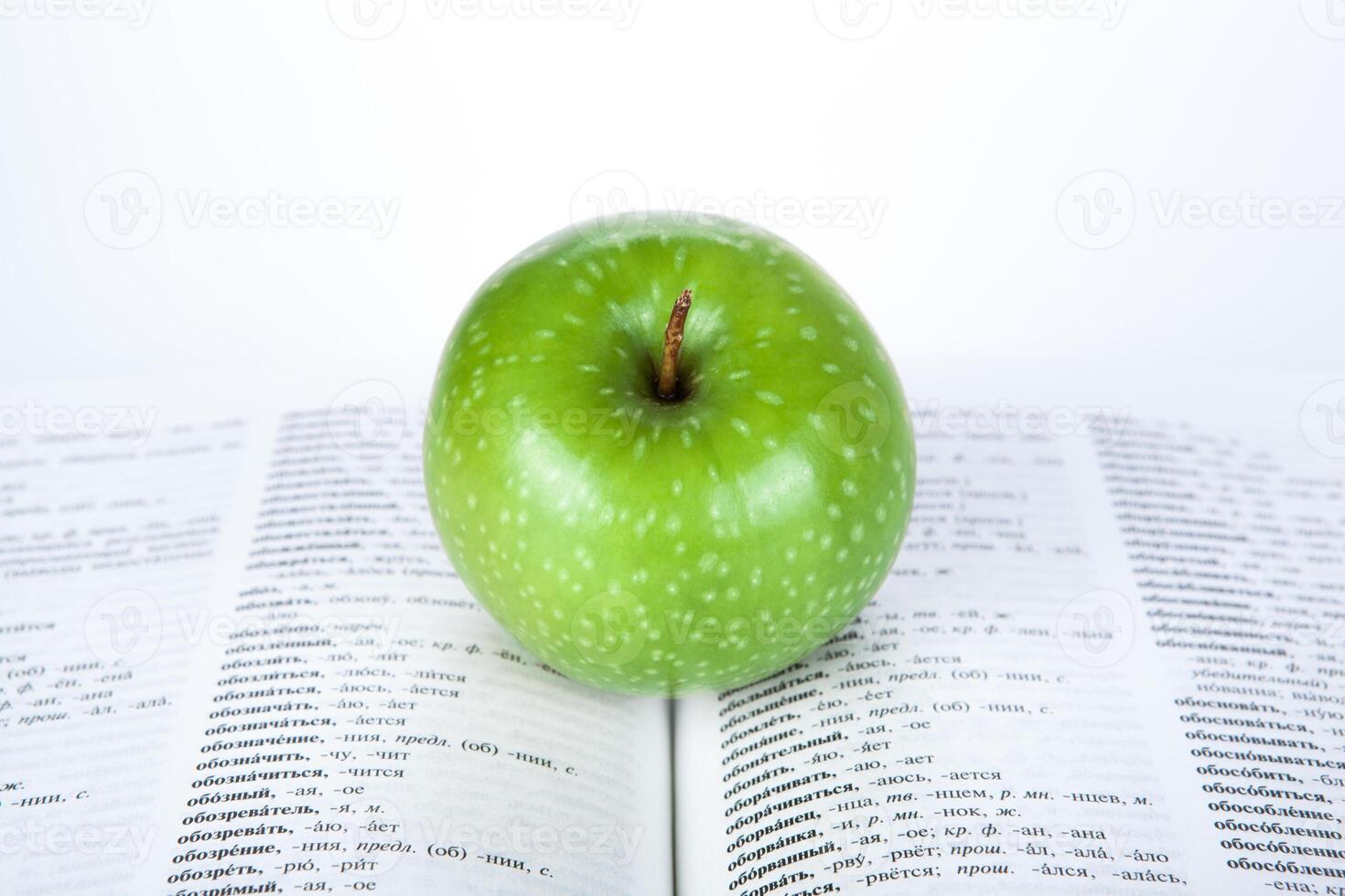 large book with green apple photo