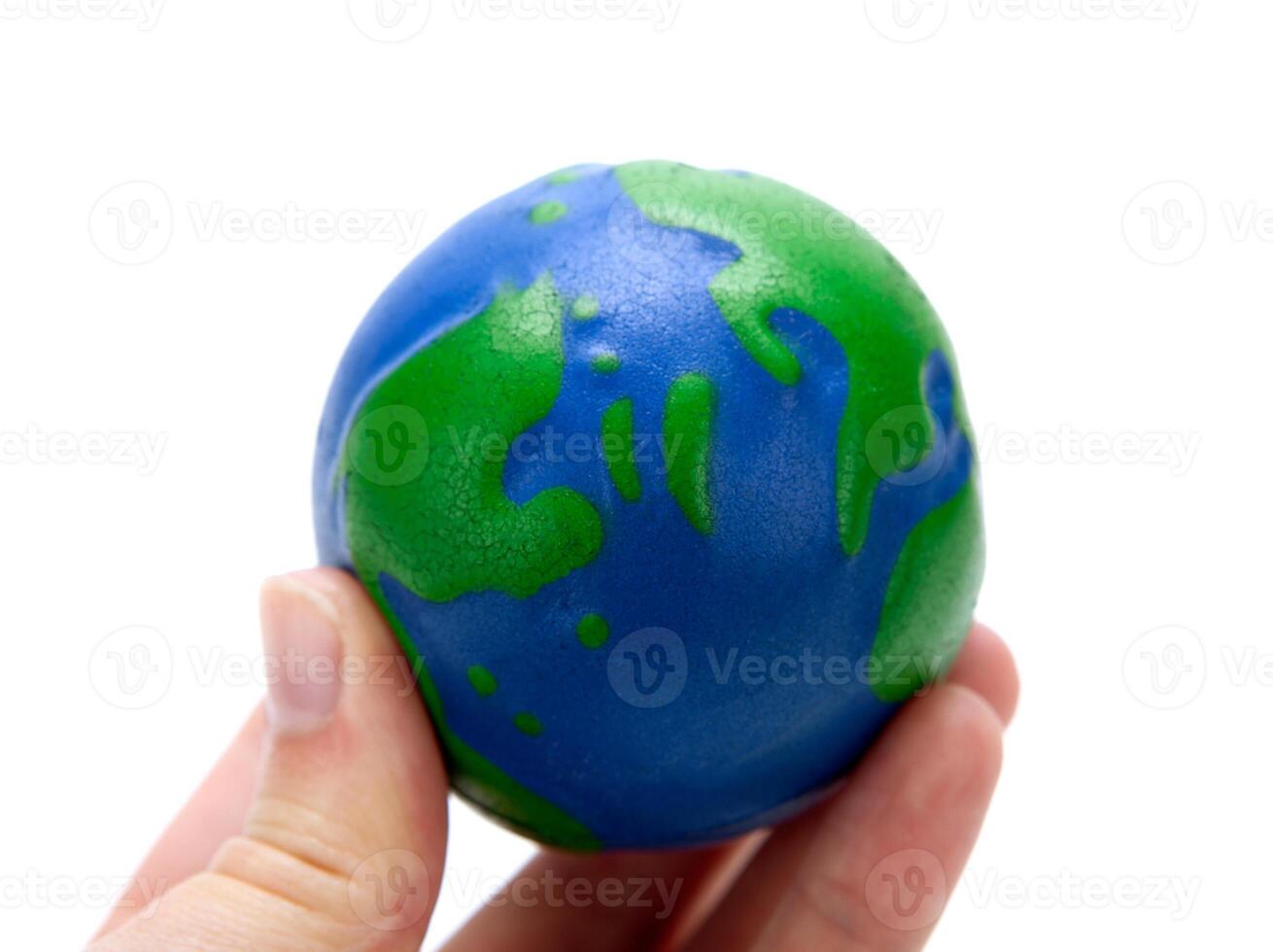 rubber ball in the form of a globe of the planet earth in the hand of man photo