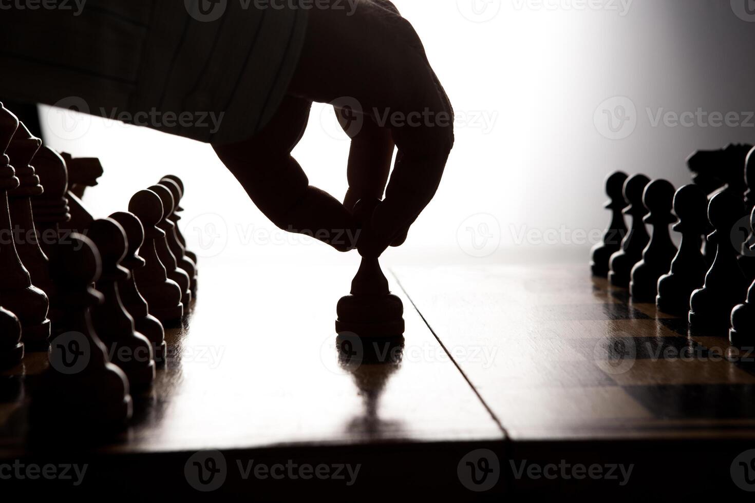 man makes a move chess figure photo