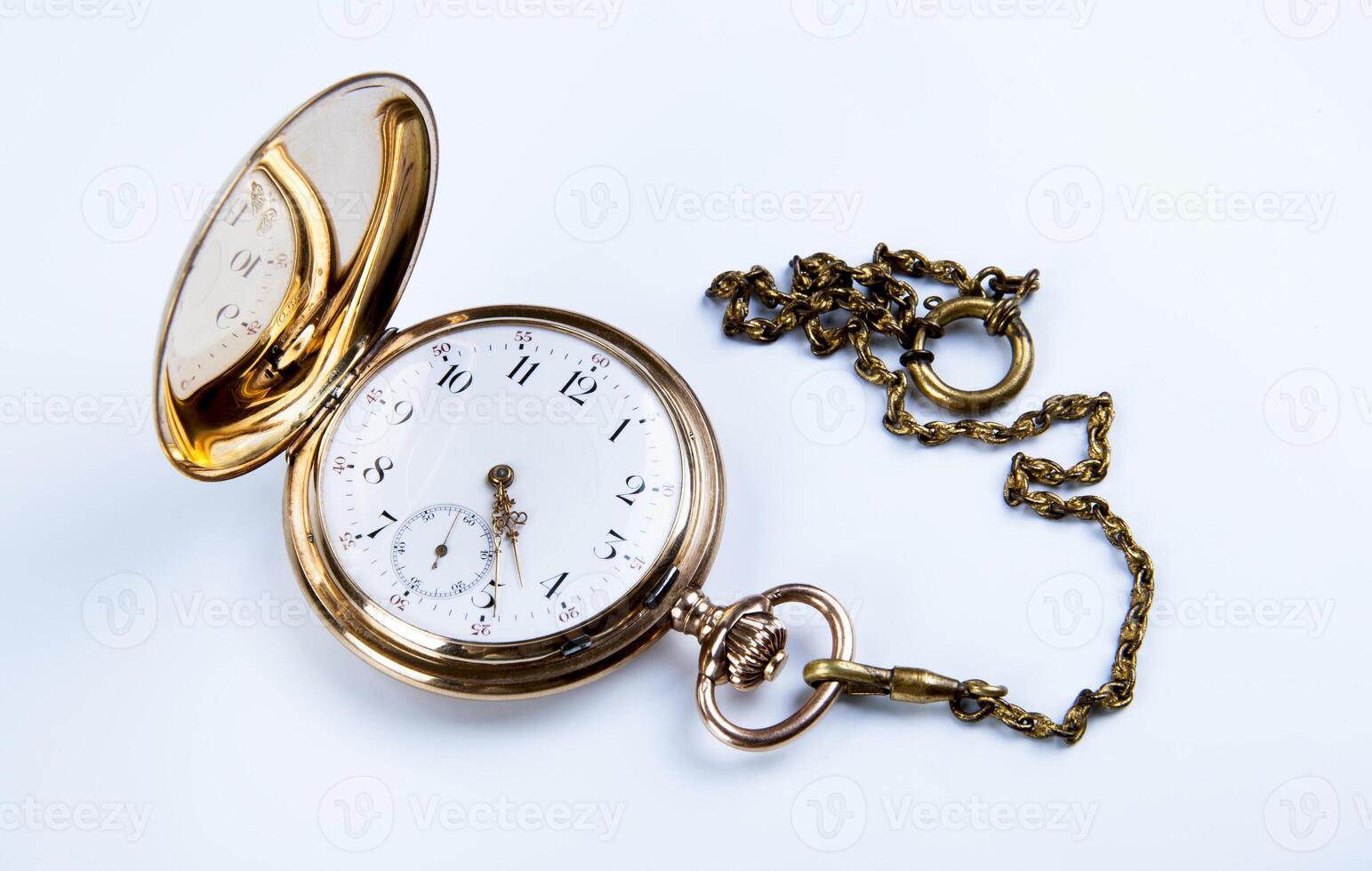 Gold pocket watch on white photo
