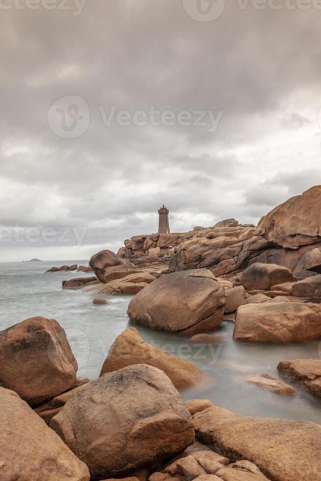 panoramic view of the famous Ploumanach lighthouse among the pink boulders photo