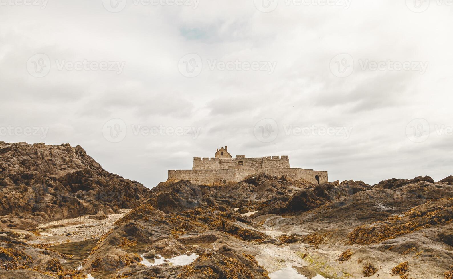 landscape of a medieval fortress on the French coast seen at low tide photo