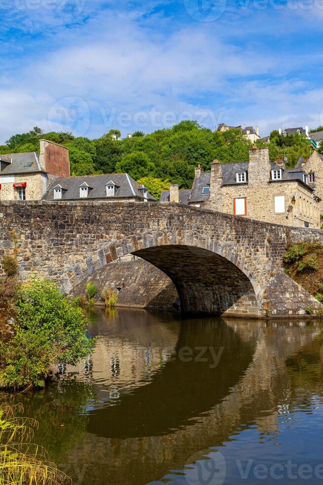 panoramic view of old stone bridge and historical medieval houses reflecting in La Rance river in Dinan town port photo