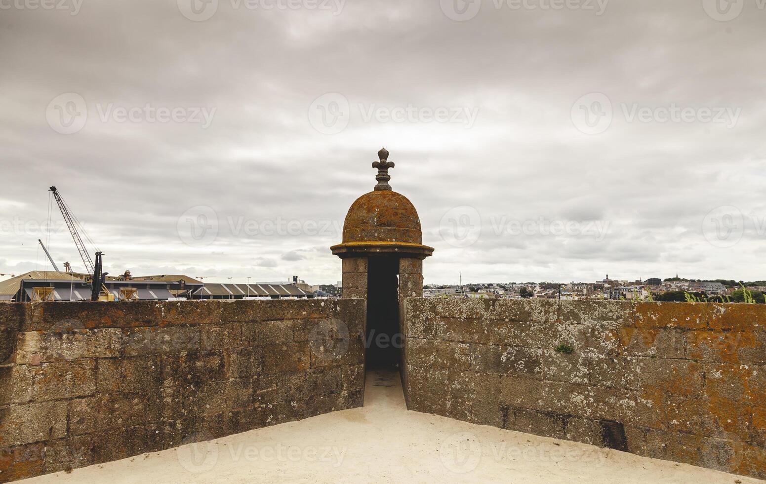 Granite walls surround the historic center of a medieval French town photo