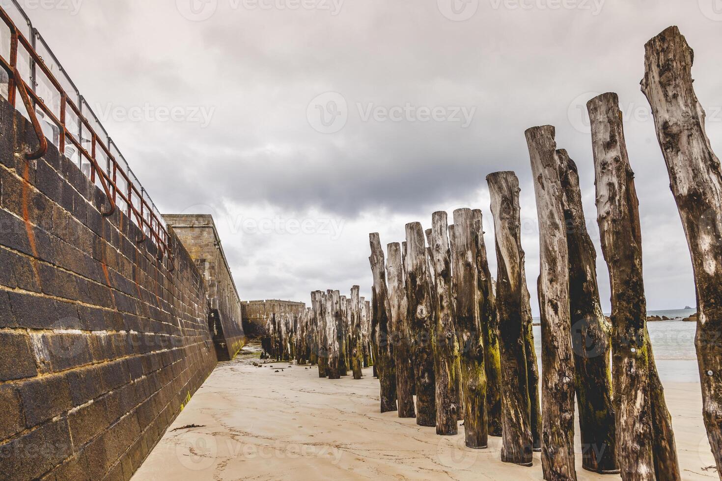 breakwater line on the beach in front of the walls of saint malo photo