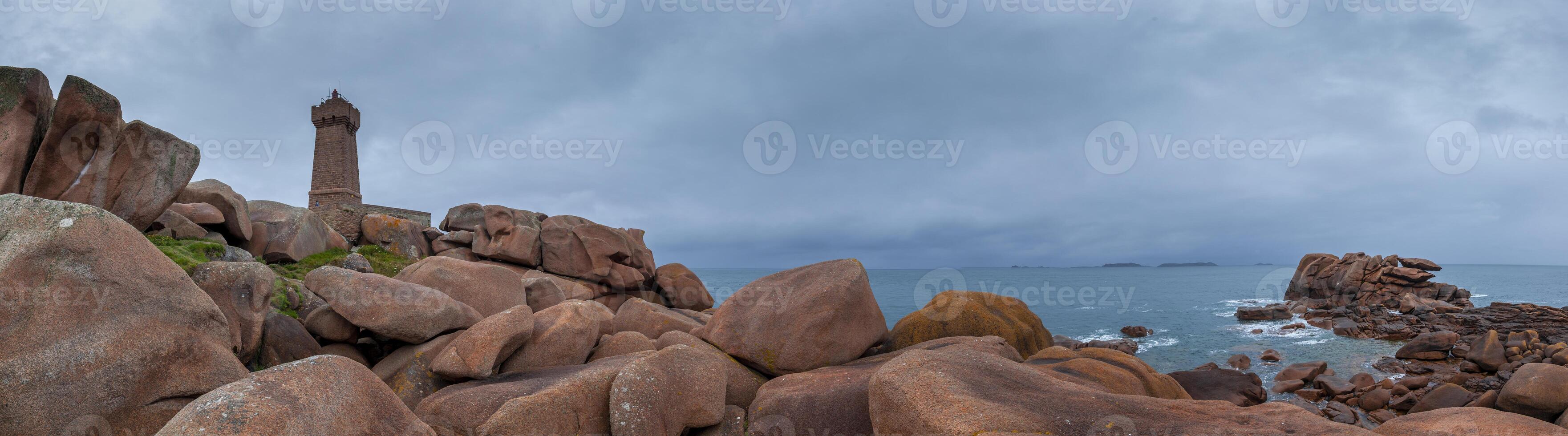 panoramic view of the famous Ploumanach lighthouse among the pink boulders photo